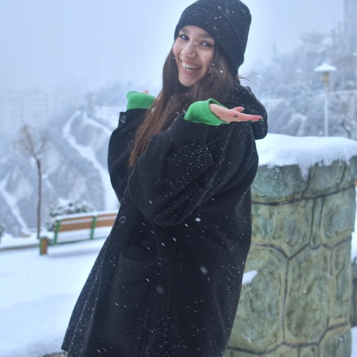 Avery Chen, Lead Design Curator at Tidal Market Note, reviewing corporate floral arrangements